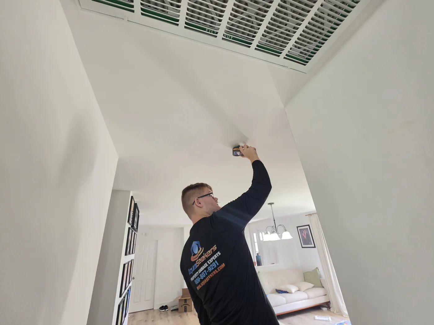 AquaSeekers team member inspecting a ceiling