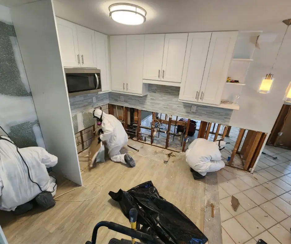 AquaSeekers crew working in protective suits on kitchen remediation